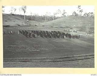 BISIATABU, NEW GUINEA. 1944-04-19. TROOPS OF THE PAPUAN INFANTRY BATTALION ON PARADE WITH THE BUGLE BAND OF THE ROYAL PAPUAN CONSTABULARY AT THEIR REAR. THE PARADE, CONDUCTED BY MAJOR GENERAL B.M. ..