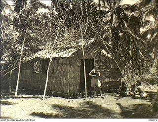 NEW GEORGIA, SOLOMON ISLANDS. 1943-03. A NATIVE WIRELESS TELEGRAPHIST OPERATOR COMING OUT OF THE RADIO HUT AT THE SEGI COASTWATCHERS STATION (ZGJ5) OPERATED BY CAPTAIN D.G. KENNEDY BRITISH SOLOMON ..