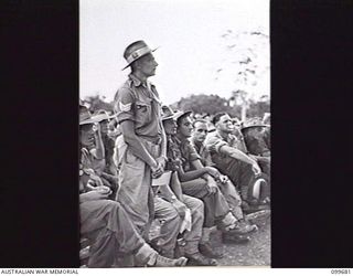 LAE, NEW GUINEA, 1946-01-28. SERGEANT A. LUCAS, LAE PRISONER OF WAR CAMP QUESTIONING THE HONOURABLE F. M. FORDE, MINISTER FOR THE ARMY, AT THE CONCLUSION OF HIS ADDRESS TO SERVICE PERSONNEL AT THE ..