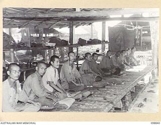 FAURO ISLAND, BOUGAINVILLE AREA. 1945-11-11. SICK JAPANESE SOLDIERS SIT TO ATTENTION IN AREA NO. 7. THEY WERE PHOTOGRAPHED DURING A TOUR OF INSPECTION OF THE JAPANESE AREAS NOS 7, 8 AND 9 ON THE ..