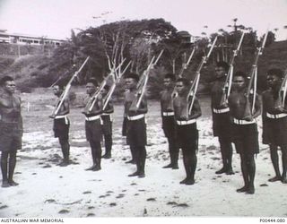 ADMIRALTY ISLANDS 1955. NEW RECRUITS OF THE PNG DIVISION OF THE RAN BEING DRILLED ON THE PARADE GROUND AT THE RAN SHORE BASE, HMAS TARANGAU. (NAVAL HISTORICAL COLLECTION)