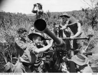 KAKAKOG, NEW GUINEA. 1943-11-07. TROOPS OF THE 12TH BATTERY, 2/4TH AUSTRALIAN LIGHT ANTI-AIRCRAFT REGIMENT DOING MAINTENANCE ON THEIR 40MM BOFORS GUN. SHOWN ARE: VX68580 GUNNER W. H. ALLEN OF ..
