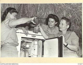 1942-11-23. UNITED STATES NURSES IN NEW GUINEA. A REFRIGERATOR IS A POPULAR INNOVATION. (NEGATIVE BY BOTTOMLEY)