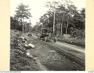 ZENAG, NEW GUINEA, 1944-02-27. A CATERPILLAR NO.12 MOTOR GRADER OF NO.4 PLATOON, 2/1ST MECHANICAL EQUIPMENT COMPANY, ROYAL AUSTRALIAN ENGINEERS ON MAINTENANCE PATROL AT THE 54 MILE POINT