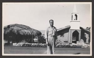 [Man Infront of Saipan Buildings]