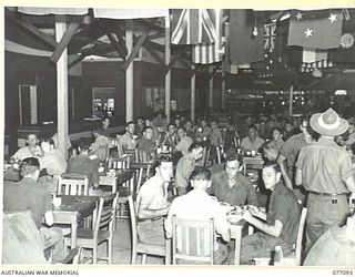 LAE AREA, NEW GUINEA. 1944-11-26. THE WELL PATRONIZED DINING ROOM AND BARS AT THE 22ND ARMY CANTEEN SERVICES OTHER RANKS CLUB AT THE LAE BASE SUB AREA