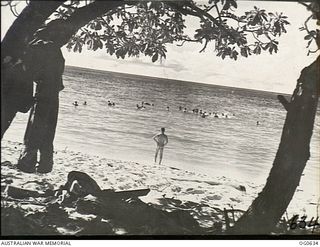 KIRIWINA, TROBRIAND ISLANDS, PAPUA. 1944-01-31. BEACH SCENE AT THE RAAF BATTLE STATION WHERE THE MEN FIND THEIR ONLY RESPITE FROM THE GRIME OF BATTLE IN SWIMMING AND BOATING