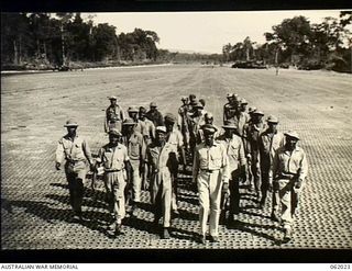 Dreger Harbour, New Guinea. 1943-12-06. Chaplain Warren J. Jenkins of Atlanta, Georgia, Chaplain of the unit, and coloured (negro) engineers of the 870th United States Aviation Engineer Battalion ..