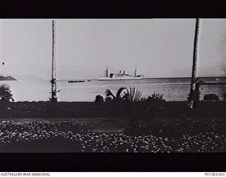 SALAMAUA, NEW GUINEA, 1940. S.S. NEPTUNA ANCHORED IN THE HARBOUR. CARGO WAS BROUGHT ASHORE IN BARGES. ON ITS RETURN VOYAGE IT TOOK INTERNEES TO AUSTRALIA FROM SALAMAUA. (DONOR H. WALTER)