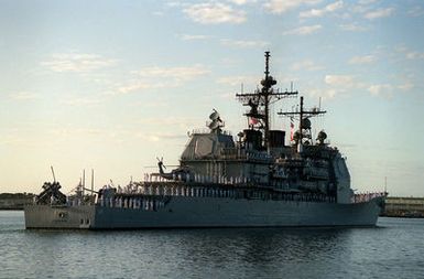 Crew members man the rails aboard the guided missile cruiser USS CHOSIN (CG-65) as the vessel moves past the USS ARIZONA MEMORIAL. The CHOSIN is taking part in an observance commemorating the 50th anniversary of the Japanese attack on Pearl Harbor