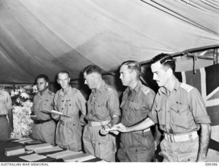 RABAUL, NEW BRITAIN, 1945-12-11. MEMBERS OF THE WAR CRIMES COURT BEING SWORN IN BEFORE THE COURT GOES INTO SESSION AT HEADQUARTERS 11 DIVISION