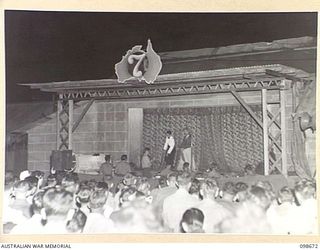 TOROKINA, BOUGAINVILLE. 1945-11-09. PRIVATE G.J. BUCKHAM, FEMALE IMPERSONATOR ON STAGE DURING THE LAST OF A SERIES OF CONCERTS PLAYED BY THE KOOKAROOS CONCERT PARTY AT 7 RAAF AIRFIELD CONSTRUCTION ..