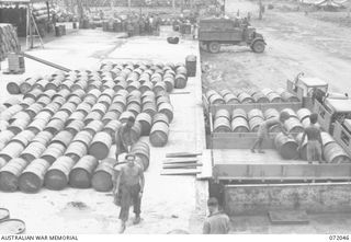 MILNE BAY, NEW GUINEA. 1944-04-04. SX25456 CORPORAL H.C. MARSHALL (1) AT THE DRUM REFILLING PLANT AT THE 2ND AUSTRALIAN BULK PETROLEUM STORAGE COMPANY TERMINAL