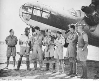 COUNTRIES NORTH AND SOUTH OF THE EQUATOR ARE REPRESENTED IN A ROYAL AIR FORCE SQUADRON NOW OPERATING AMERICAN BOMBERS IN THE WESTERN DESERT. SOME OF THE PERSONNEL ARE SHOWN IN THIS PICTURE AND ..