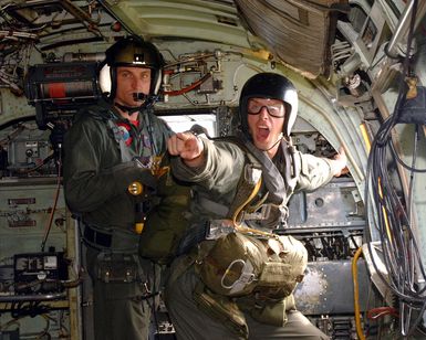 A Jump MASTER from Explosive Ordnance Disposal Mobile Unit Five, yells to jumpers that it is time to go during static line jumps from a CH-46 Sea Knight Helicopter from Helicopter Combat Support Squadron Five, Andersen Air Base, Guam