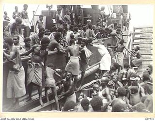 KAHILI, BOUGAINVILLE. 1945-10-02. NATIVES, WHO WERE EVACUATED BY THE JAPANESE TO FAURO ISLAND, RETURNING TO THE BUIN AREA FOR REHABILITATION UNDER AUSTRALIAN NEW GUINEA ADMINISTRATIVE UNIT ..