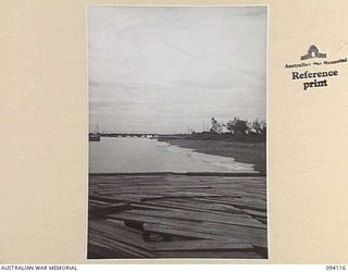 BUNA, NEW GUINEA, 1945-07-03 TO 1945-07-04. THE RUINS OF THE DOCKS AT BUNA BEACH