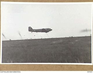 RAGITSUMA, NEW GUINEA, 1943-09-30. "BISCUIT BOMBERS". TRANSPORT AIRCRAFT DROPPING FOOD RATIONS TO FORWARD TROOPS OF THE 21ST AUSTRALIAN INFANTRY BRIGADE IN THE MARKHAM VALLEY