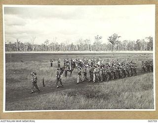 WONDECLA, QLD. 1944-04-15. MEMBERS OF H.Q. COMPANY 2/1ST INFANTRY BATTALION GIVE "EYES RIGHT" AS THEY MARCH PAST THEIR COMMANDING OFFICER , NX163 LIEUTENANT COLONEL P.A. CULLEN, DSO. (1), WITH THE ..