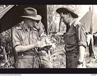 NADZAB, NEW GUINEA. 1943-09-20. VX20592 LIEUTENANT J. C. G. KEALY, STAFF CAPTAIN LEARNER (LEFT), PRIVATE PALMER (CENTRE, PARTIALLY OBSCURED) AND WX3254 CAPTAIN J. P. K. MURDOCH (RIGHT), ALL OF ..