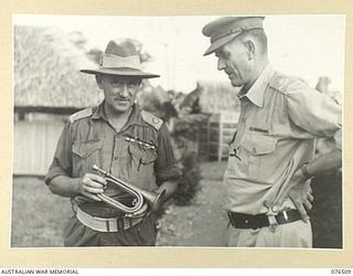 LAE, NEW GUINEA. 1944-10-18. NX201 MAJOR H.E. GALE, MBE, CAMP COMMANDANT, 2ND AUSTRALIAN CORPS (1) SHOWING NGX350 MAJOR E.W. JENYNS, DEPUTY ASSISTANT DIRECTOR OF NATIVE LABOUR AND OFFICER IN ..