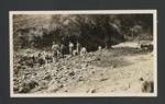 Group of men standing near a creek bed, c1900 to ?