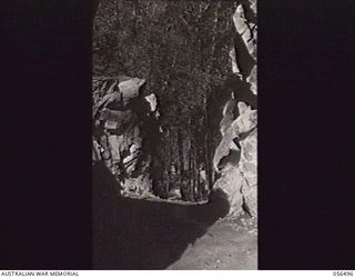 REINHOLD HIGHWAY, NEW GUINEA, 1943-08-31. ROCK CUTTING NEAR CENTRE CAMP. THIS ROCK WAS THE HARDEST ENCOUNTERED ON THE WHOLE ROAD AND TOOK THREE AND A HALF MONTHS TO CUT OUT