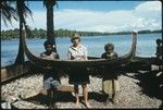 Frances Harwood with two men and miniature canoe