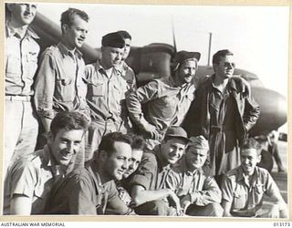 Port Moresby (?) New Guinea. 1942-09-02. A group of United States Army Air Force (USAAF) pilots and their RAAF co-pilots standing under the wing of a C-110 (DC-5) transport aircraft