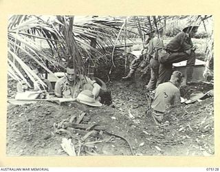BULATAGI, NEW GUINEA. 1944-07-31. PERSONNEL OF D TROOP, 28TH FIELD BATTERY, IN THE COMMAND POST BEHIND THE GUNS DURING A PRACTICE SHOOT WITH THEIR 25 POUNDERS. IDENTIFIED PERSONNEL ARE:- SX9264 ..