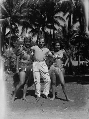 [Portrait of couple in Tahitian costume, with photographer]