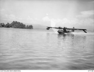 JACQUINOT BAY, NEW BRITAIN. 1944-11-21. THE RAAF CATALINA FLYING BOAT, WHICH IS ON THE MAIL RUN BETWEEN NEW BRITAIN AND NEW GUINEA, GATHERS SPEED AS SHE PREPARES TO TAKE OFF FOR THE RETURN JOURNEY ..