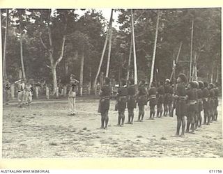 LAE, NEW GUINEA, 1944-03-27. MAJOR-GENERAL B. M. MORRIS DSO (1), GENERAL OFFICER COMMANDING AUSTRALIAN NEW GUINEA ADMINISTRATIVE UNIT TAKING THE SALUTE AT THE ROYAL PAPUAN CONSTABULARY BARRACKS ..