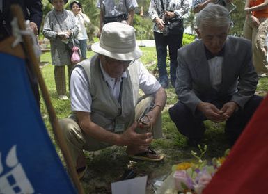 Twenty-seven Japanese veterans from tank units stationed on the neighboring island of Saipan during World War II (WWII) came to pay respects to fallen comrades during a 60th Anniversary reunion. These veterans had family and friends stationed on Guam, and they didn't learn of their fates for years following the war. They came today with their families to place flowers, burn incense, light candles and give prayers at Tarague Beach a sight of major conflict during the war. The Japanese tank units at Tarague were the last enemy tanks on Guam and with their destruction by the United States Marine Corp (USMC) all organized resistance on Guam had ended