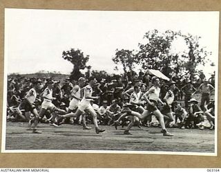 DONADABU, PAPUA, NEW GUINEA. 1944-01-01. THE START OF THE 3000 YARDS CROSS COUNTRY CHAMPIONSHIP AT THE 15TH INFANTRY BRIGADE GYMKHANA. IDENTIFIED PERSONNEL ARE: CORPORAL H. W. PAYNE (1); CORPORAL ..