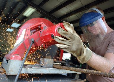 US Navy (USN) Constructionman Apprentice (BUCA) Sean F. Shaver, assigned to the Naval Mobile Construction Battalion 40(NMCB-40), uses a circular chop saw to cut a concrete rebar at Camp Covington, Guam (GUM). NMCB-40 is currently on a scheduled deployment at Guam