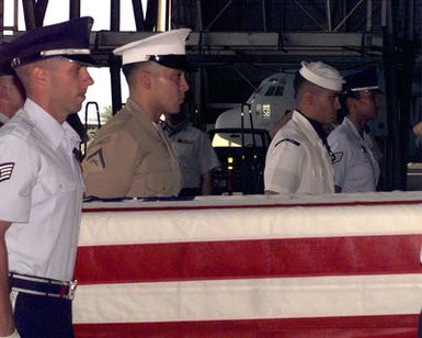 A Joint Service Military Honor Guard carry the remains of repatriated service members, returned from Vietnam, to be identified at the Central Identification Lab of Hawaii on Hickam Air Force Base. The reparation ceremony was held on August 29th, 2000