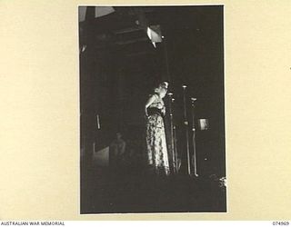 LAE, NEW GUINEA. 1944-07-24. MARTHA TILTON SINGING DURING A CONCERT ARRANGED FOR THE TROOPS BY THE JACK BENNY SHOW