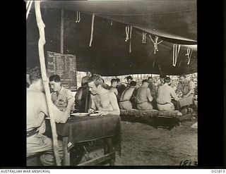 MOMOTE, LOS NEGROS ISLAND, ADMIRALTY ISLANDS. C. 1944-04. PILOTS OF NO. 76 (KITTYHAWK) SQUADRON RAAF IN THE MESS TENT