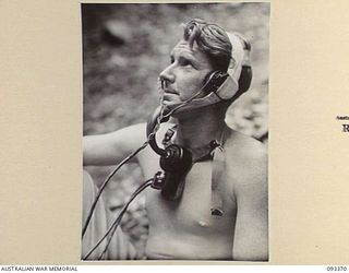 BARGES HILL, CENTRAL BOUGAINVILLE, 1945-06-26. PTE W.R. JOHNSON, 8 INFANTRY BATTALION (AIF), TELEPHONE CONTROLLER OF THE FUNICULAR RAILWAY BEING CONSTRUCTED BY 23 FIELD COMPANY, ROYAL AUSTRALIAN ..