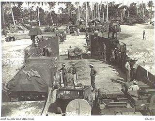 MADANG, NEW GUINEA. 1944-06-27. TROOPS OF THE 7TH DOCKS OPERATING COMPANY, UNLOADING AUSTRALIAN ARMY MOTOR VEHICLES FROM AN AMERICAN ARMY LCT (LANDING CRAFT TRANSPORT)