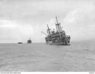 OFF PORT MORESBY, PAPUA. 1942-08-30. M.V. MALAITA ENCHORED OFF PORT MORESBY AFTER HAVING BEEN TORPEDOED BY AN ENEMY SUBMARINE THE PREVIOUS DAY. THE CRAFT IN THE BACKGROUND ARE WAITING TO TOW HER ..