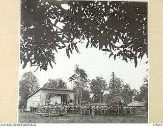 LAE, NEW GUINEA. 1944-09-03. PERSONNEL OF HEADQUARTERS, NEW GUINEA FORCE ATTENDING A SERVICE TO COMMEMORATE THE 5TH ANNIVERSARY OF THE OUTBREAK OF WAR CONDUCTED BY NX156703 CHAPLAIN R.S. PICKUP, ..