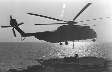 A CH-53 Sea Stallion helicopter drops equipment onto the deck of the amphibious assault ship USS GUAM (LPH 9) as the 22nd Marine Amphibious Unit redeploys from Beirut at the conclusion of a multinational peacekeeping operation