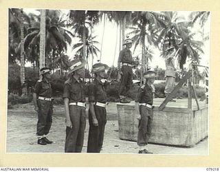 AITAPE, NEW GUINEA. 1945-02-23. VX17 MAJOR-GENERAL J.E.S. STEVENS, DSO, ED, GENERAL OFFICER COMMANDING 6TH DIVISION (1) TAKES THE SALUTE AS MEMBERS OF THE 19TH INFANTRY BRIGADE MOVES PAST THE ..