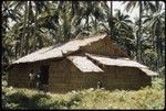 Two people outside a house