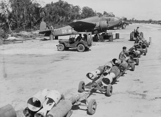 TADJI AIRSTRIP, AITAPE, NORTH EAST NEW GUINEA. 1945-03-30. THIS BOMB LOAD ON THE TROLLEYS IS FOR THE JAPANESE IN THE TORRICELLI MOUNTAINS OF NEW GUINEA AND IS TO BE DELIVERED BY BEAUFORT BOMBER ..