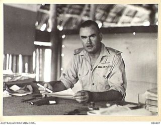 LABU, NEW GUINEA. 1944-12-18. MAJOR G D MITCHELL MC DCM, COMMANDING OFFICER, 43 LANDING CRAFT COY, AT WORK IN HIS OFFICE. (Photographer: Sgt F W Butt)