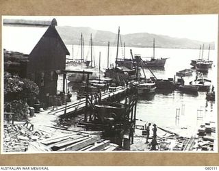 NAPA NAPA, NEW GUINEA. 1943-11-12. GENERAL VIEW OF THE 2ND AUSTRALIAN WATERCRAFT WORKSHOPS, AUSTRALIAN ELECTRICAL AND MECHANICAL ENGINEERS, SHOWING SHIPS WAITING TO BE REPAIRED OR UNDERGOING REFITS