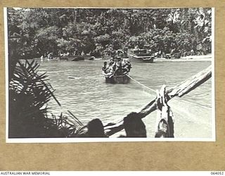 GOALING RIVER, NEW GUINEA. 1944-01-21. A SECTION OF AUSTRALIAN INFANTRY CROSSING THE RIVER IN A JAPANESE FERRY WHICH WAS LEFT BEHIND BY THE RETREATING ENEMY